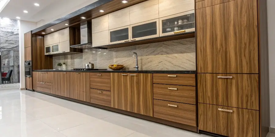 A Smart Combination of Kitchen Cabinet Woods A beautifully designed kitchen showcasing different wood textures and finishes on the cabinets, island, and shelving