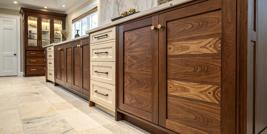 Hybrid Materials in High-End Cabinetry A sophisticated two-tone kitchen with matte lacquer uppers and a walnut veneer island