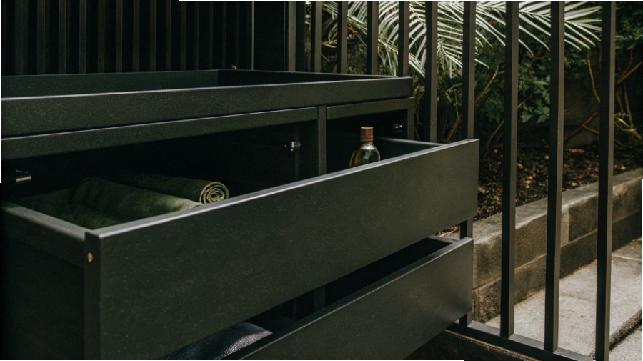 A sleek, modern kitchen in a humid coastal home featuring stainless steel cabinets that look brand new.